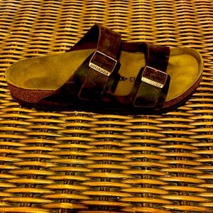 Brown and black Birkenstocks